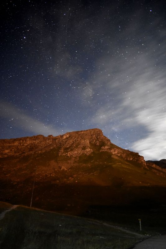 Stars above a moonlit rocky ridge