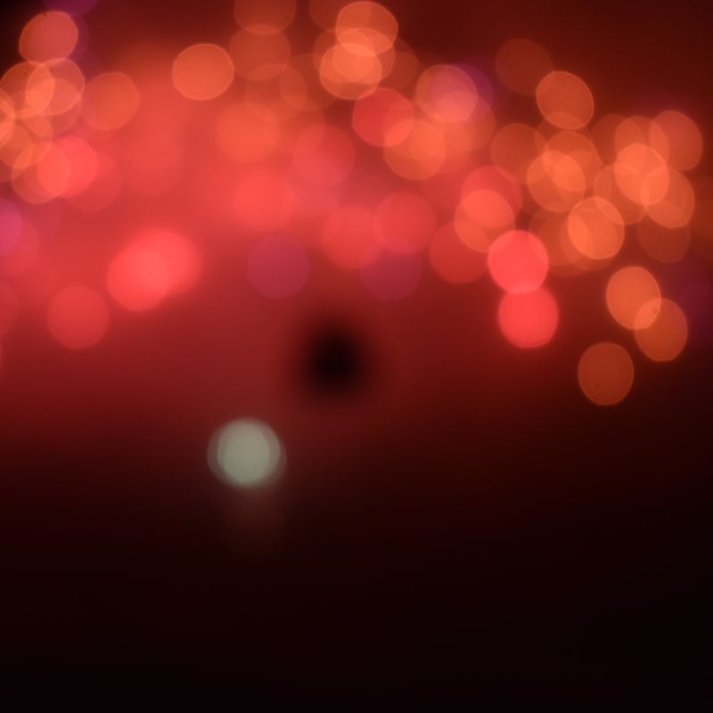 Abstract out-of-focus red and orange lights against the dark