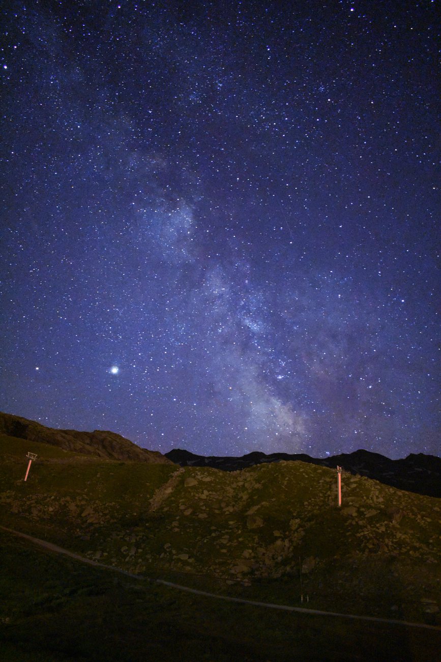 The Milky Way rising over a mountain pass at night